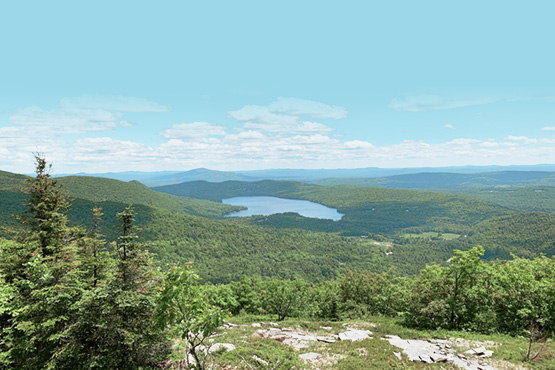 scenic view with mountains and lake in background