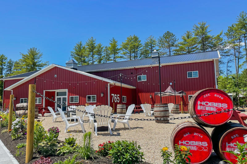 outdoor seating and red beer barrels at hobbs brewing company