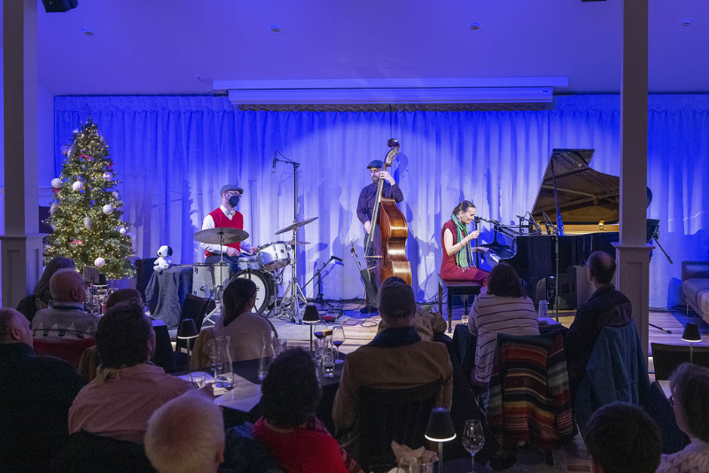 musicians on stage at a winery holiday event
