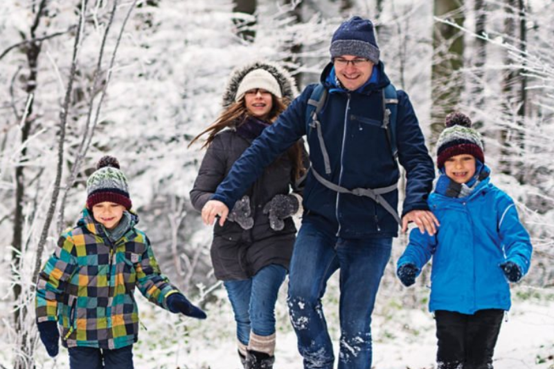 Family walking in snowy forest