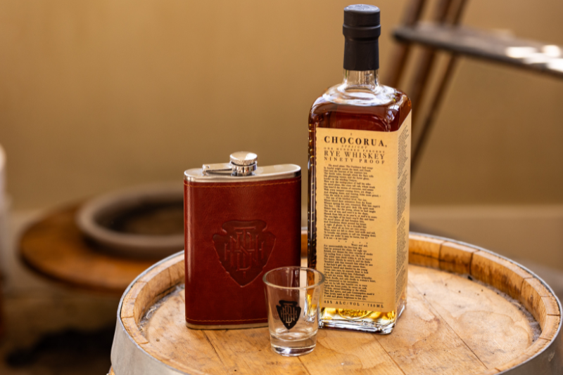 promo shot of chocorua whiskey from tamworth distilling on a whiskey barrel