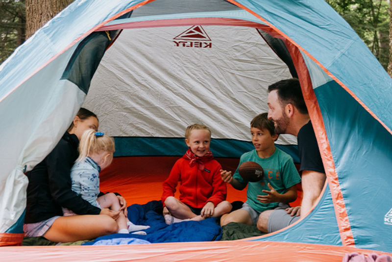 family camping in blue tent
