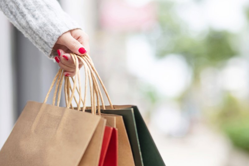 person holding multiple shopping bags