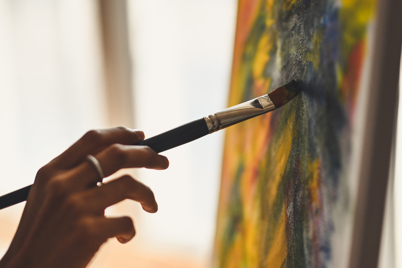 person painting on a canvas