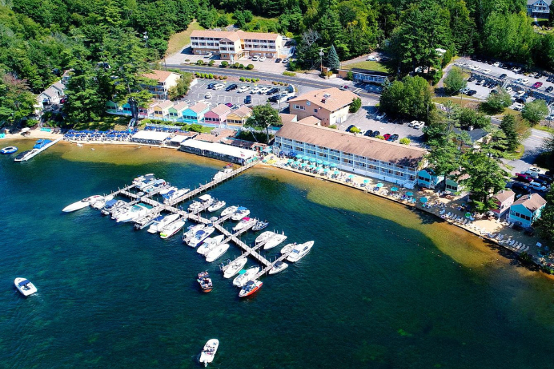 waterfront resort with colorful cottages and boats on lake