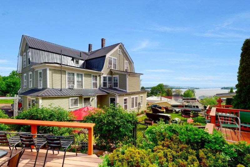 greenery and seating areas outside lakeview inn in nh on a sunny day