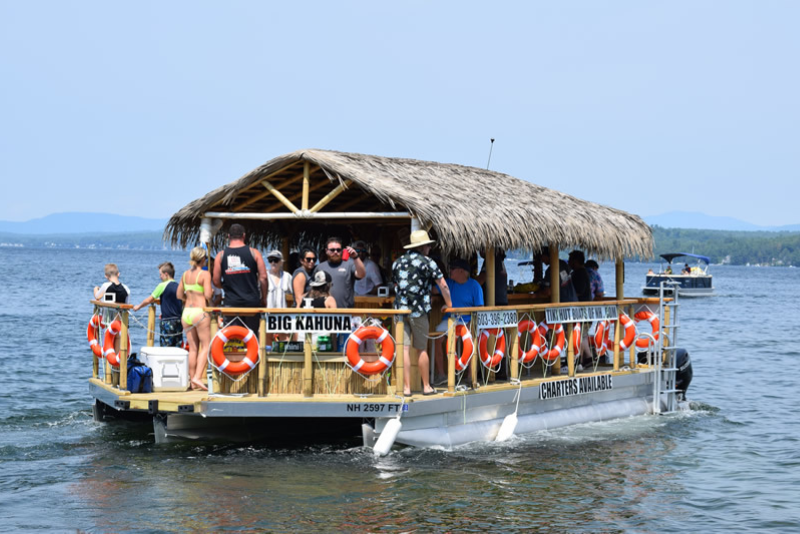 tiki hut-themed boat on a lake