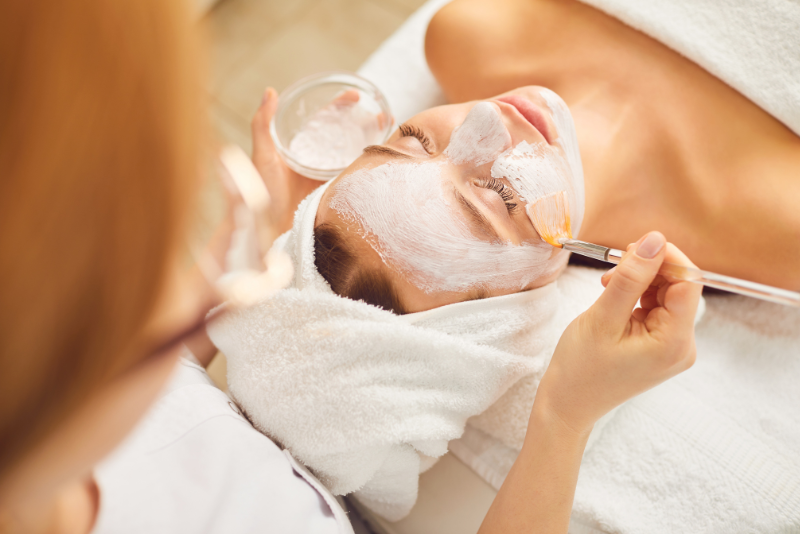 woman on treatment table at spa getting a facial