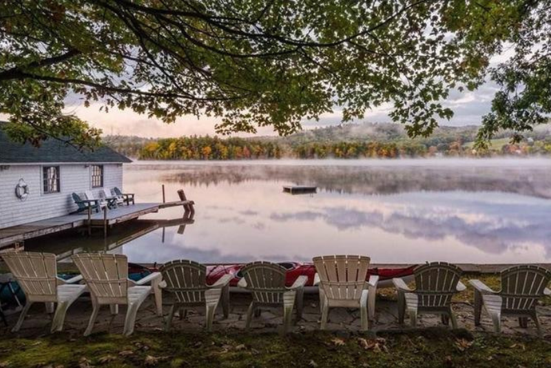 adirondack chairs set on a lawn overlooking the lake in center harbor, nh