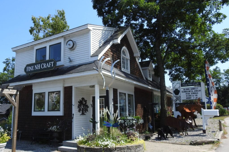 league of NH craftsmen building with sign reading "fine NH craft" in meredith, new hampshire