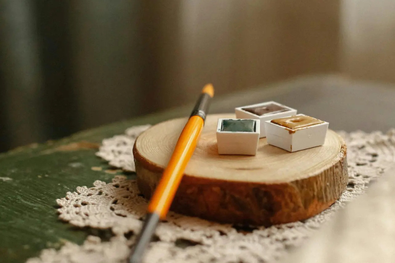 paintbrush and paints lying on table