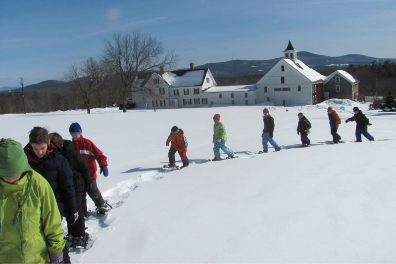 group of kids snowshoeing at prescott farm
