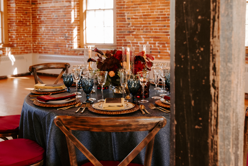 close-up of wedding table with fall colors inside mill building